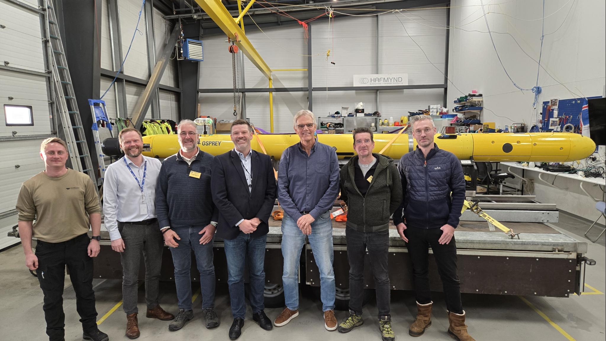 Team of six men standing before the AUV