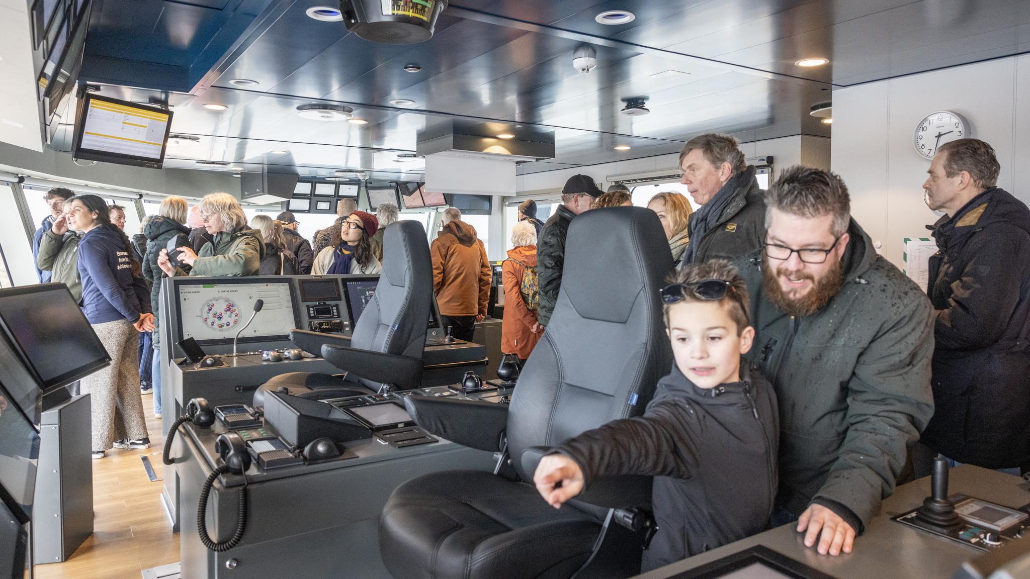 A large crowd gathers in the operating room of the 