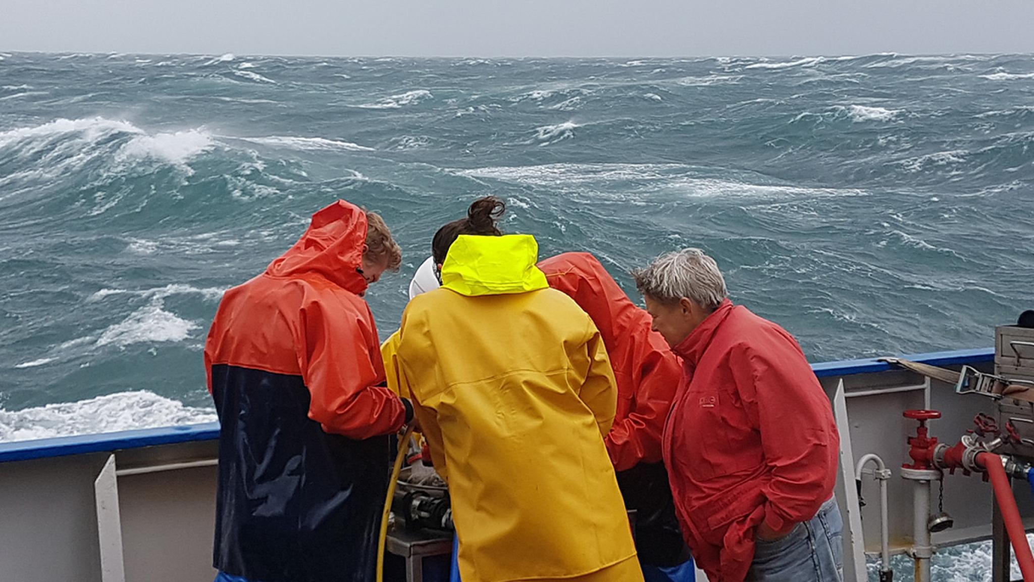 The crew of RV Pelagia working to get the equipment out, before the storm hits (image: Justin Tiano/NIOZ)