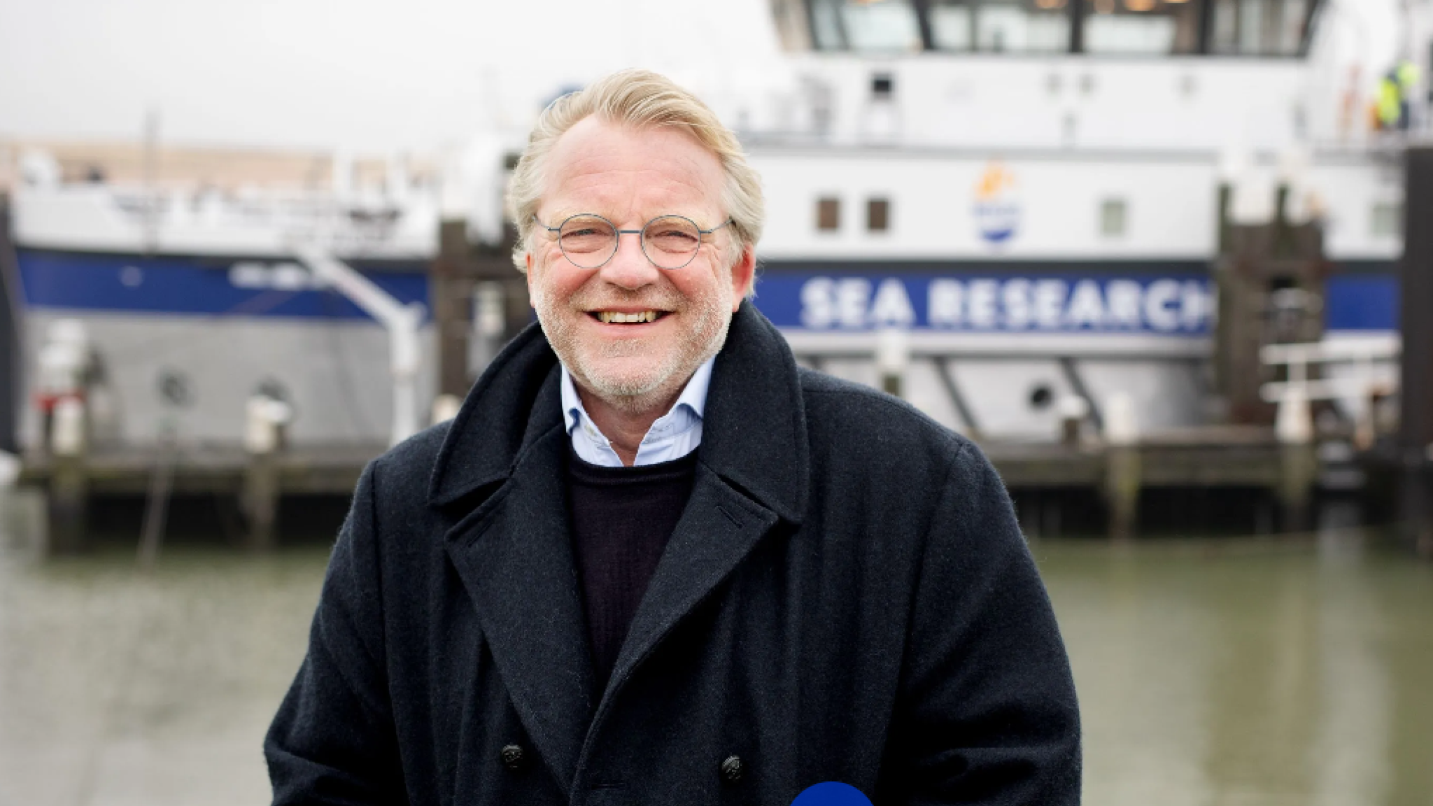 Han Dolman at the NIOZ harbour in front of a research vessel