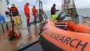 People on the back of the deck with a view of the Wadden Sea. They are collecting samples from the mudflats and in the foreground you can see a rubber boat with ‘searesearch’ written on it. Photo by Oscar Franken.