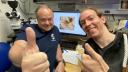 Two happy researchers, thumbs up in the camera