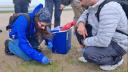Taking a sediment sample to check for bacteria on the beach. (photo: R. Gorniak)