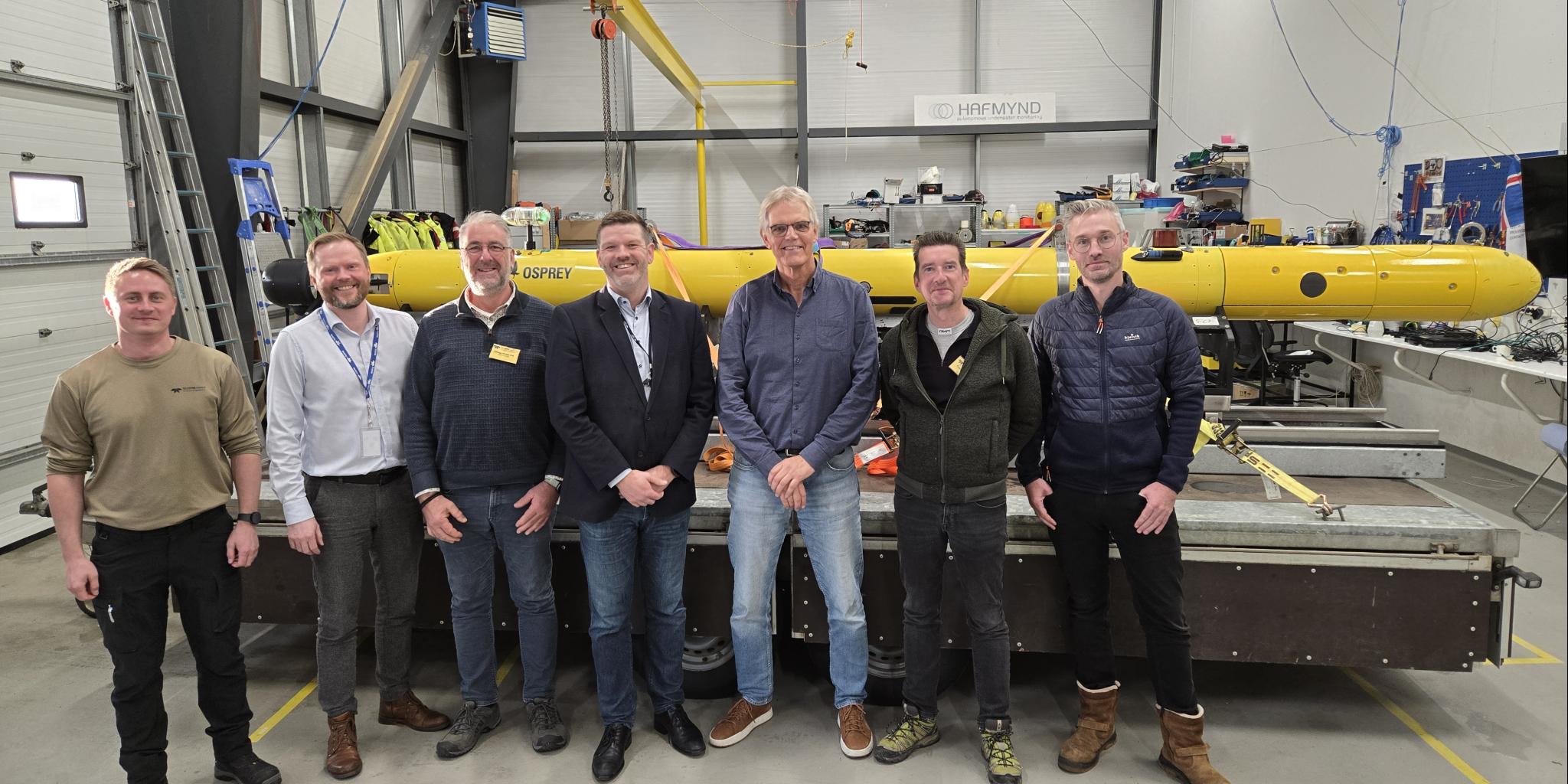 Team of six men standing before the AUV