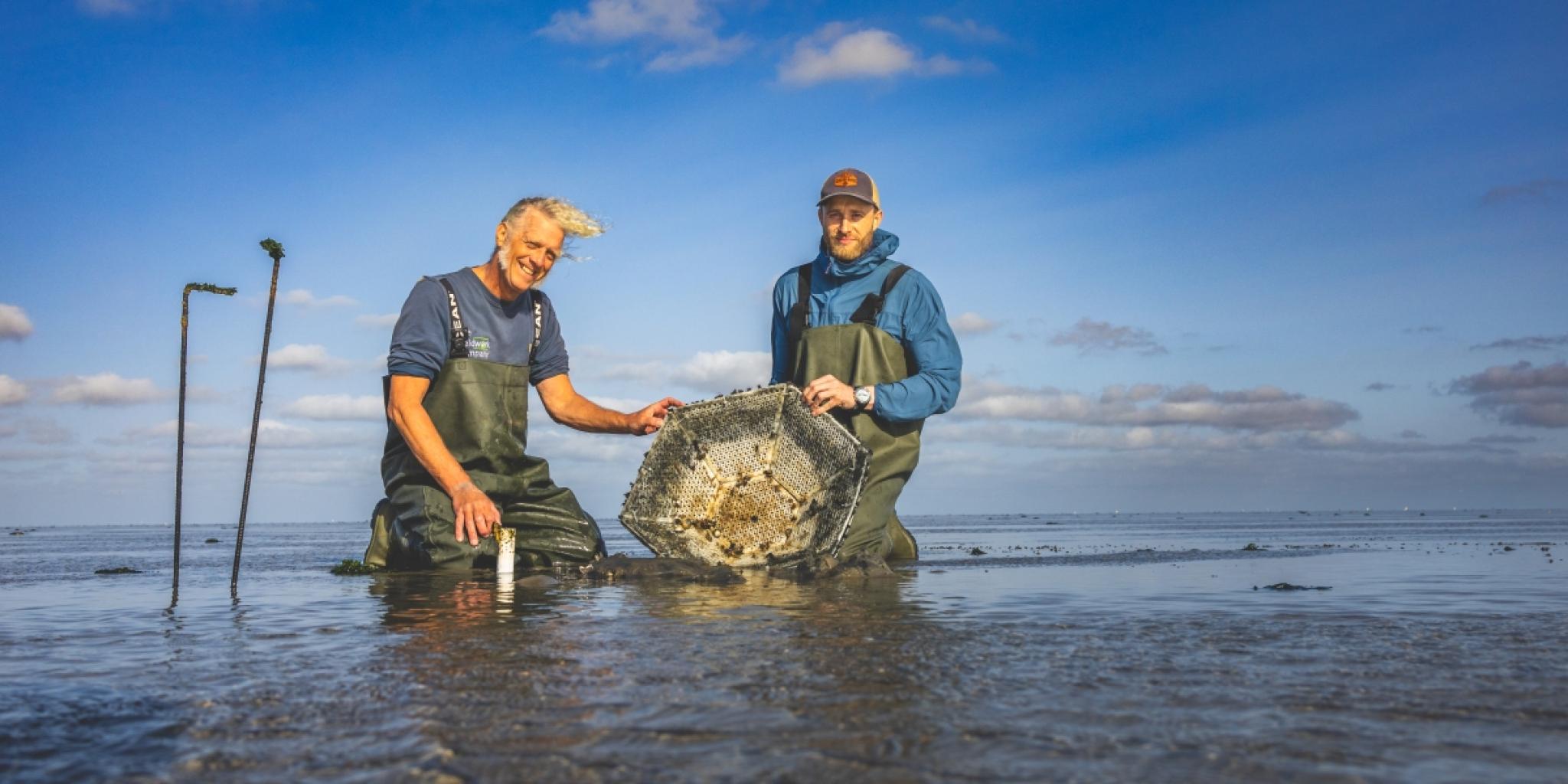 Two persons showing an artificial reef