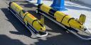 Three yellow torpedo-like research devices await launch aboard the research vessel Pelagia.