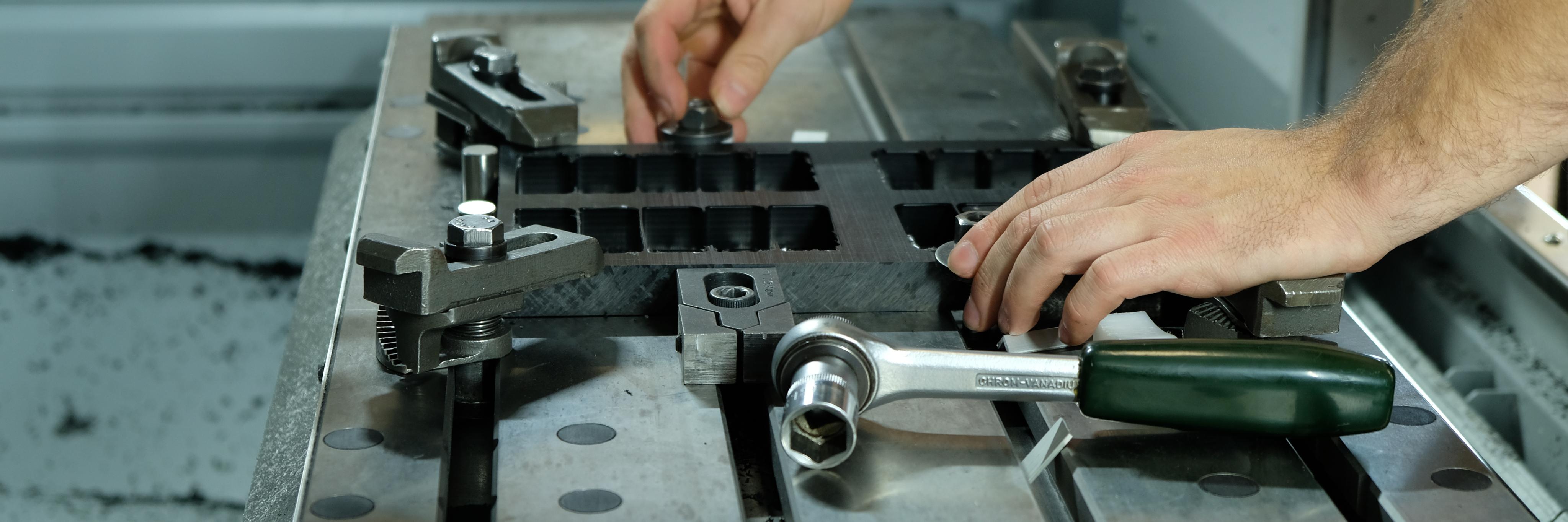 Close-up of hands at work in the NOIZ workplace.