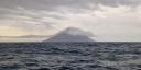 The typical volcano-shape of the Stromboli sticking out of the Tyrrhenian Sea.